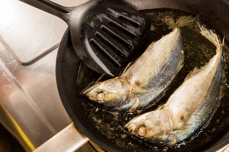 Frying fresh Mackerels in a pan.の写真素材