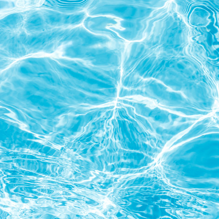 Background of rippled pattern of clean water in blue swimming pool
