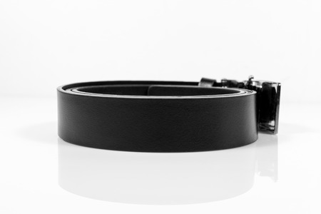 Leather belt closeup on white background.の写真素材