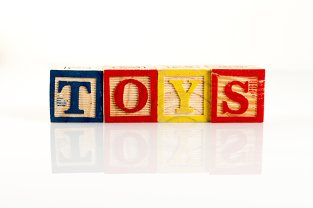 The letters T,O,Y,S spelling toys with wooden blocksの写真素材