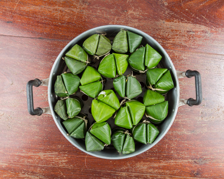 Thai dessert made from rice and banana wrapped in banana leaves,Traditional sweets.の写真素材