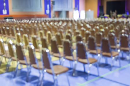 Blur of empty chair in meeting or conference room.