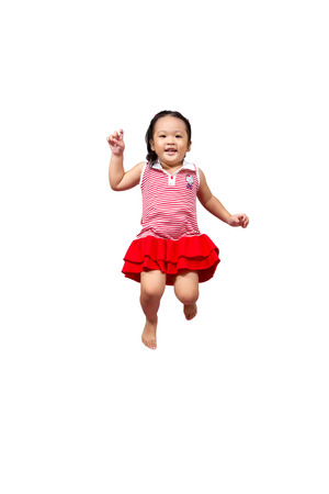 Little Asian girl jumping on isolated on white.の写真素材