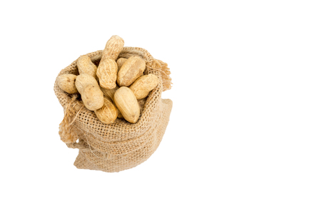 Peanuts in sack isolated on white background.の写真素材