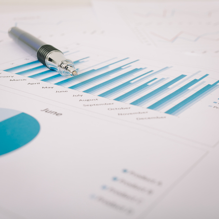 Marketing report chart and graph analysis with penの写真素材