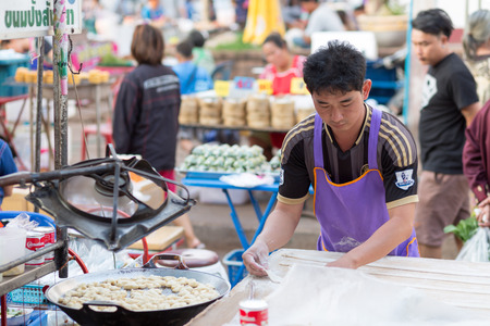 UDONTHANI , THAILAND - JANUARY 12, 2016 - Vendors selling deep-fried dough stick in the market.のeditorial素材