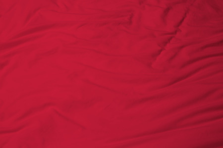 creased red cloth material fragment as a background.の写真素材