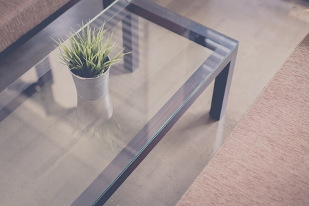 Potted grass flower over wooden table background with copy space.の写真素材