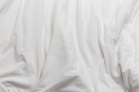 creased white cloth material fragment as a background.