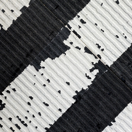 The surface of the tiles that are black and white.