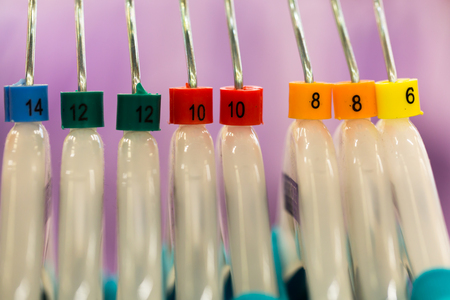 close up of clothes hanger with nuber color sizing label.の写真素材