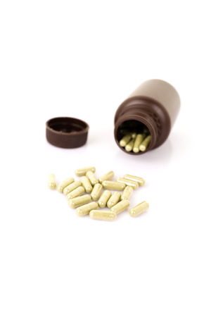 Herbal medicine capsules on white background with copy spaceの写真素材