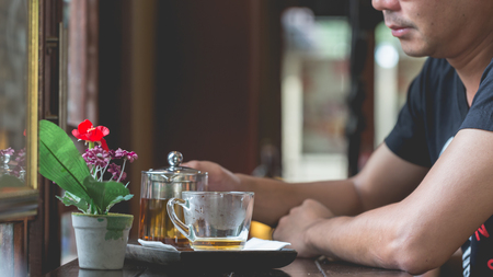 Man sitting in the restaurant with a glass of tea,Relax with a cup of tea.の写真素材