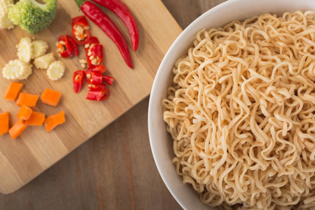 Instant noodles in bowl on wood backgroundの写真素材