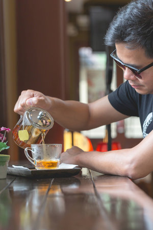 Man sitting in the restaurant with a glass of tea,Relax with a cup of tea