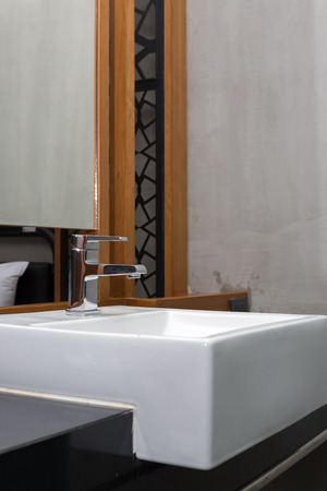 faucet and washbasin at bathroom.の写真素材