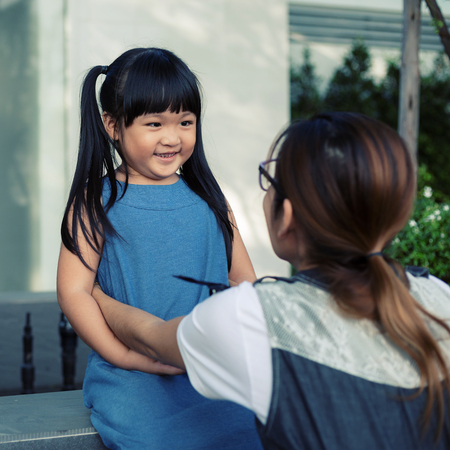 Portrait of a happy son playing with mother in the parkの写真素材