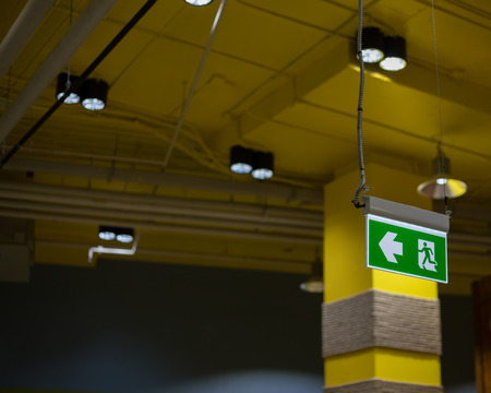 Emergency exit sign in modern offices inside an industrial plant.の写真素材