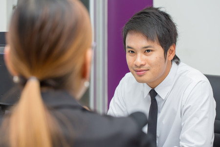 friendly businessman in white shirt wiyh black tie service with a smile.の写真素材