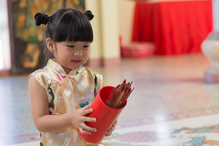 Close up of little asian girl hold Esiimsi ,horoscope prediction equipment.の写真素材