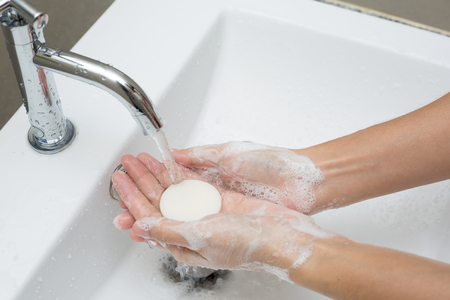 Washing of hands with soap under running water.の写真素材