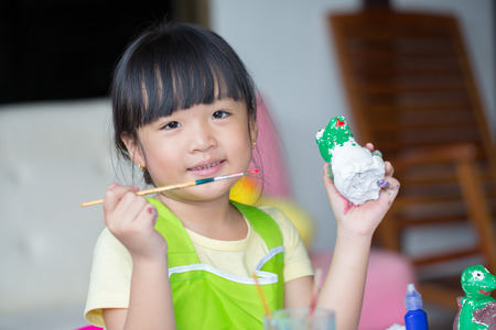 Asian girl painted on plaster doll.の写真素材
