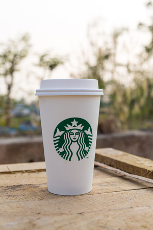 Bangkok, Thailand - Feb 22,2016 : Starbucks take away coffee cup with logo on sleeve, Starbucks brand is one of the most world famous coffeehouse chains from USAのeditorial素材
