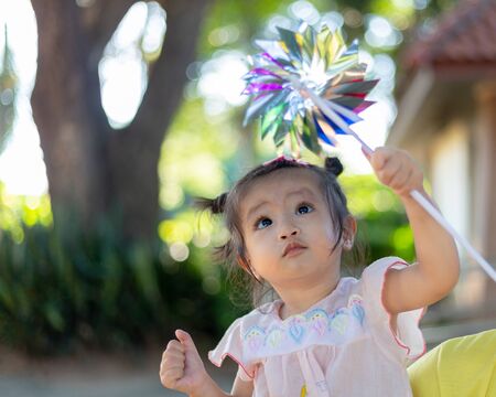 Asian girl playing wind turbine.の写真素材