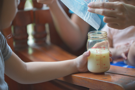 Breastfeeding mothers Pour the baby bottleの写真素材