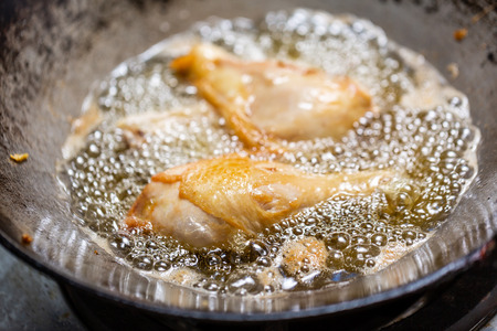 Fry the chicken in a pan with boiling oilの写真素材