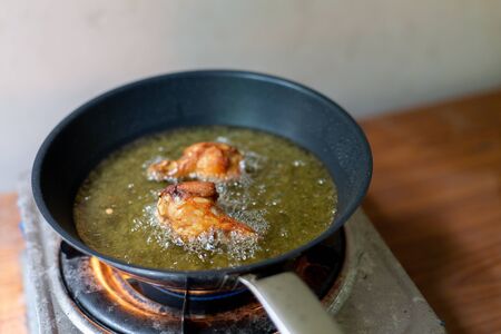 Fry the chicken in a pan with boiling oilの写真素材