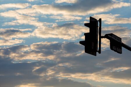 Traffic light black silhouette on sky background.の写真素材