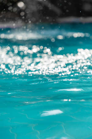 Bokeh light background in the pool,Water In Swimming Pool Texture Backgroundの写真素材