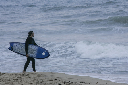 Surfer look at surfing wave at beachのeditorial素材