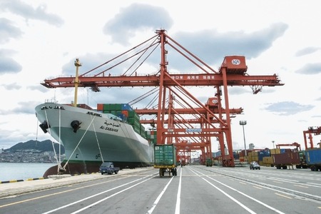 Container ship being unloaded in the Port of Busan.