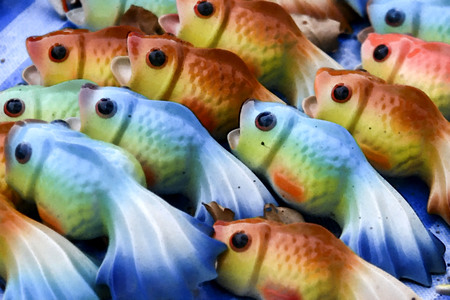 Oil painted ceramic fish displayed on the street market in thailand.の写真素材