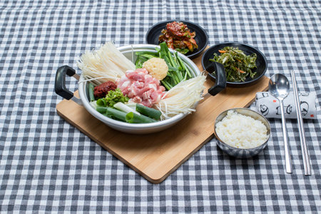 Kimchi pork stew decorate on the check pattern table.の写真素材