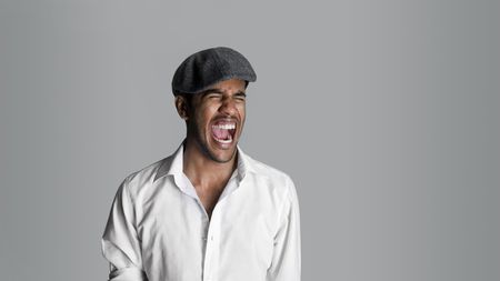 Fashion model lets off a scream with a wide mouthの写真素材