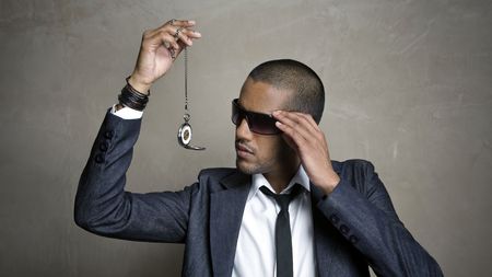 Business man looks at the time on his watchの写真素材