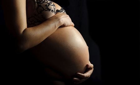 Beautiful belly of a nine month pregnant woman