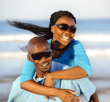 Happy African American couple enjoy the beachの写真素材