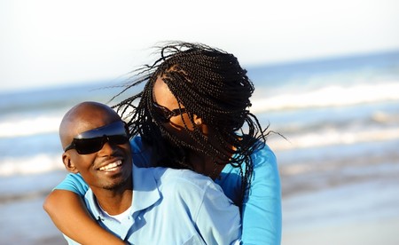 Happy African American couple enjoy the beachの写真素材
