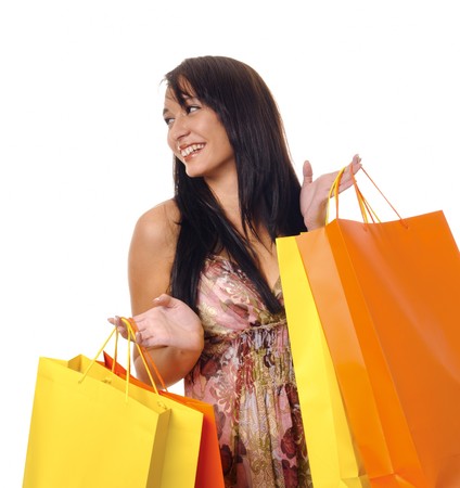 Gorgeous brunette girl with bright yellow and orange shopping bagsの写真素材