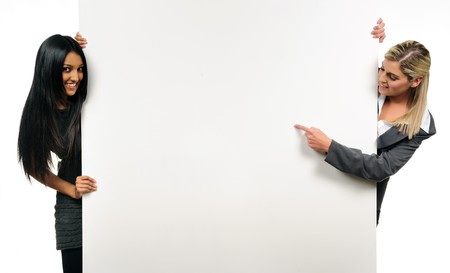 Happy, cheerful business girls hold a presentation boardの写真素材