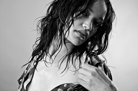 Alluring wet fashion model takes her top offの写真素材