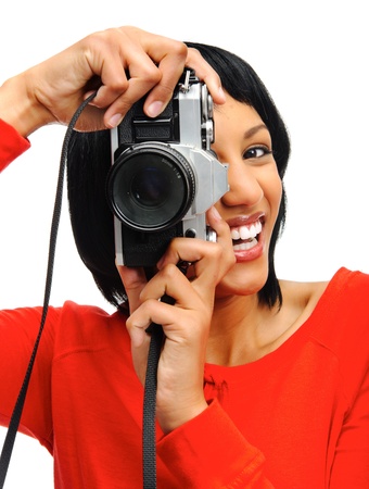 Pretty woman takes a picture with a vintage SLR camera の写真素材