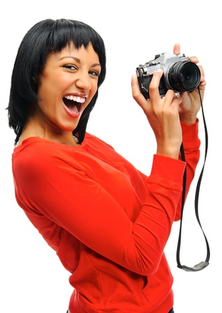 Pretty woman having fun with a vintage SLR camera の写真素材