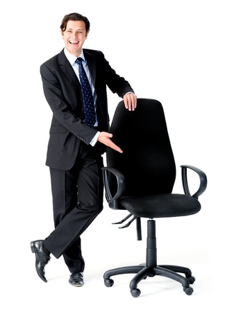 Happy businessman gestures to an empty seat, a recruitment concept の写真素材
