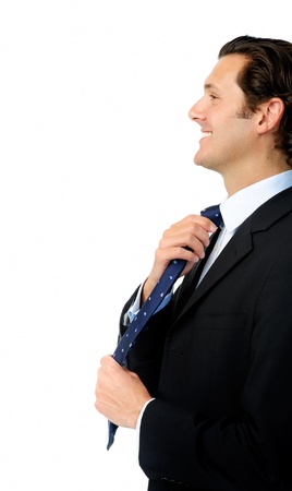Handsome man adjusts his tie while getting ready to workの写真素材