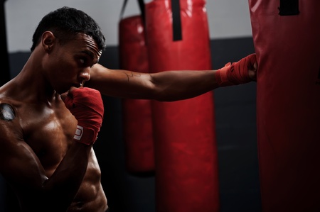 action of a boxing martial arts fighter training on a punching bag in the gymの写真素材